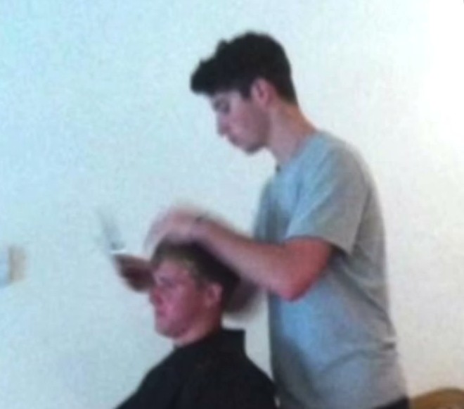 Young Tony cutting a friend’s hair at home